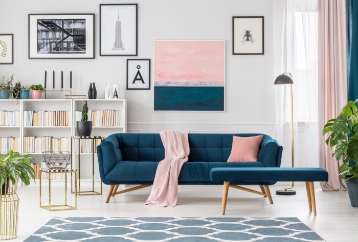 Blue sofa, wall art, and bookcase in a contemporary decor-style living room in Edmonton, AB
