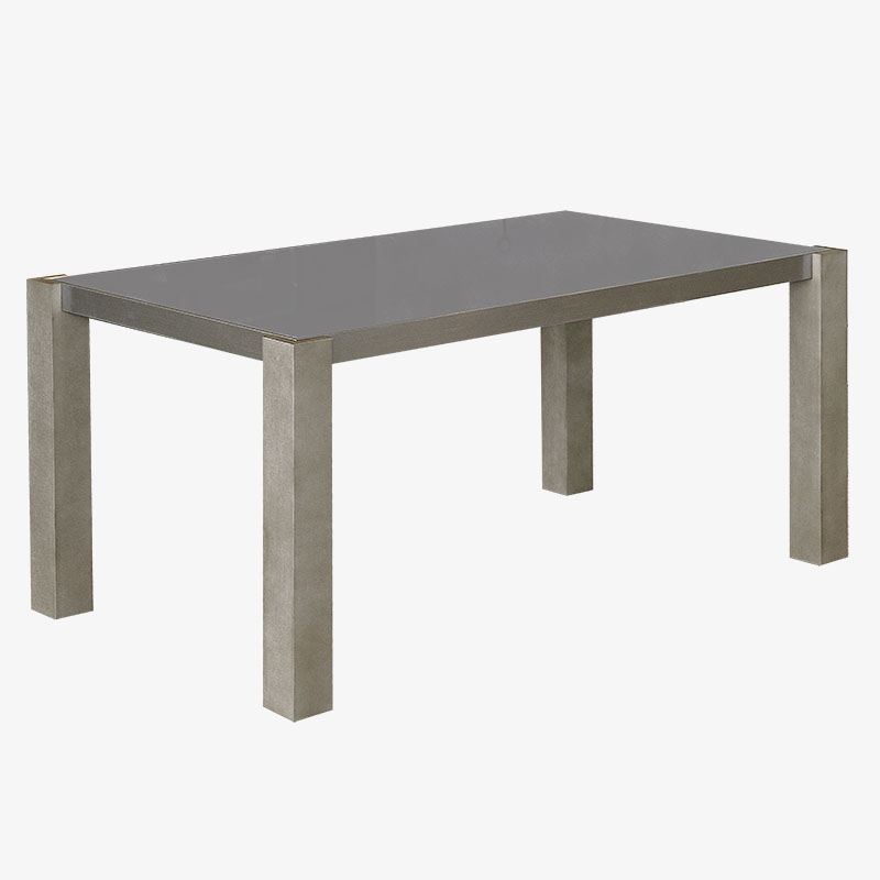 Modern rectangular grey tempered glass dining table with thick square legs and a contemporary minimalist style.